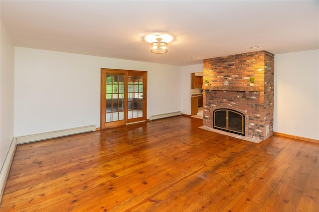 162 Lippincott Rd, Wallkill, NY 12589 - unfurnished living room featuring a baseboard radiator, wood-type flooring, and a fireplace