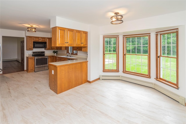 162 Lippincott Rd, Wallkill, NY 12589 - kitchen with electric range, black microwave, brown cabinetry, a peninsula, and a baseboard heating unit