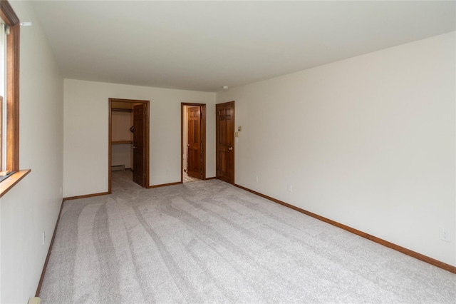 162 Lippincott Rd, Wallkill, NY 12589 - unfurnished bedroom with light carpet, a spacious closet, baseboard heating, and a closet