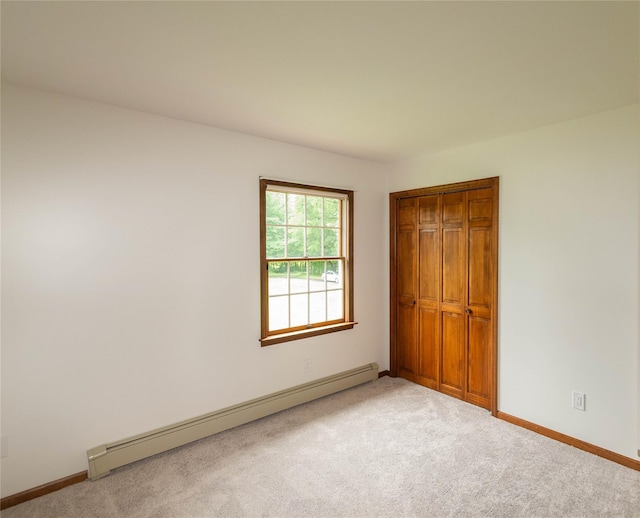 162 Lippincott Rd, Wallkill, NY 12589 - unfurnished bedroom with baseboard heating, carpet, and a closet