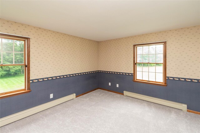 162 Lippincott Rd, Wallkill, NY 12589 - carpeted empty room featuring a baseboard heating unit, wallpapered walls, and wainscoting