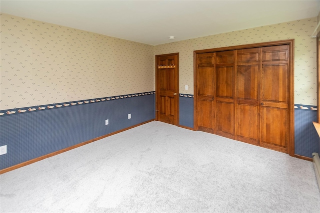 162 Lippincott Rd, Wallkill, NY 12589 - unfurnished bedroom featuring wallpapered walls, carpet floors, a wainscoted wall, and a closet