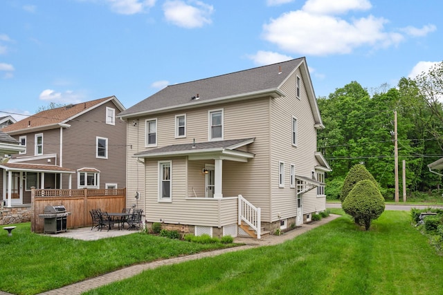 323 Hooker Ave, Poughkeepsie, NY 12603 - back of property with a patio area and roof with shingles