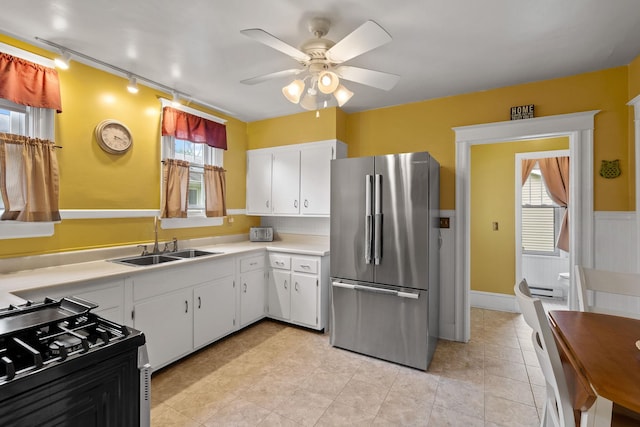323 Hooker Ave, Poughkeepsie, NY 12603 - kitchen with stainless steel appliances, rail lighting, light countertops, a ceiling fan, and plenty of natural light