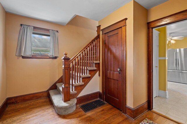 323 Hooker Ave, Poughkeepsie, NY 12603 - stairs with baseboards, a ceiling fan, and wood finished floors