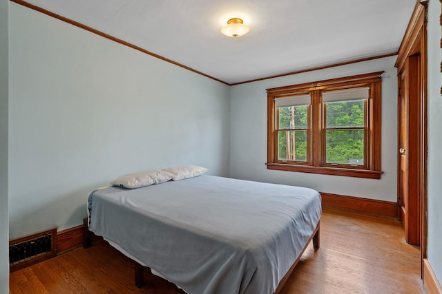 323 Hooker Ave, Poughkeepsie, NY 12603 - bedroom with ornamental molding, wood finished floors, and baseboards