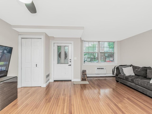 117 Sunset Blvd Unit 10117, Bronx, NY 10473 - foyer entrance with light wood-type flooring, a ceiling fan, baseboards, and a wall mounted air conditioner
