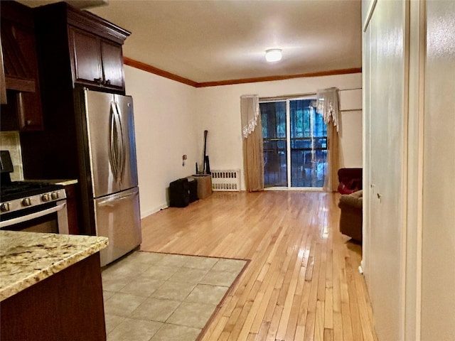 2813 W 30th St, Brooklyn, NY 11224 - kitchen with stainless steel appliances, crown molding, radiator heating unit, light wood-style floors, and dark brown cabinets