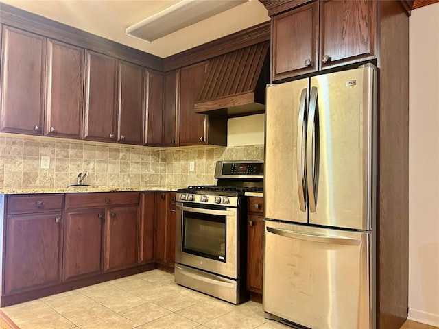 2813 W 30th St, Brooklyn, NY 11224 - kitchen featuring appliances with stainless steel finishes, light tile patterned floors, light stone countertops, tasteful backsplash, and custom exhaust hood