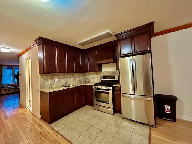 2813 W 30th St, Brooklyn, NY 11224 - kitchen with stainless steel appliances, ornamental molding, tasteful backsplash, a sink, and light wood finished floors
