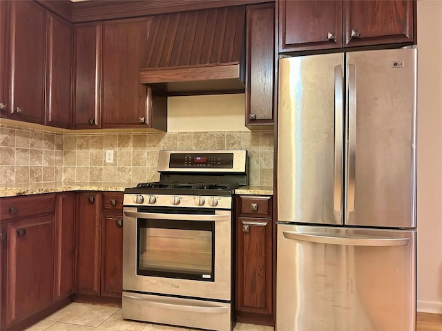 2813 W 30th St, Brooklyn, NY 11224 - kitchen with stainless steel appliances, backsplash, light stone counters, and light tile patterned floors