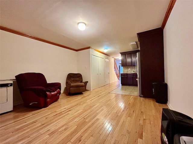 2813 W 30th St, Brooklyn, NY 11224 - living area featuring crown molding, light wood-style floors, and baseboards