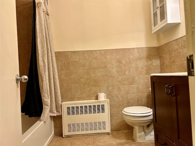 2813 W 30th St, Brooklyn, NY 11224 - bathroom with radiator, toilet, heating unit, tile patterned floors, and tile walls