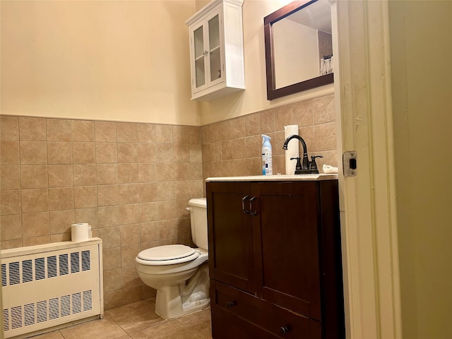 2813 W 30th St, Brooklyn, NY 11224 - bathroom featuring radiator heating unit, tile walls, toilet, tile patterned flooring, and vanity