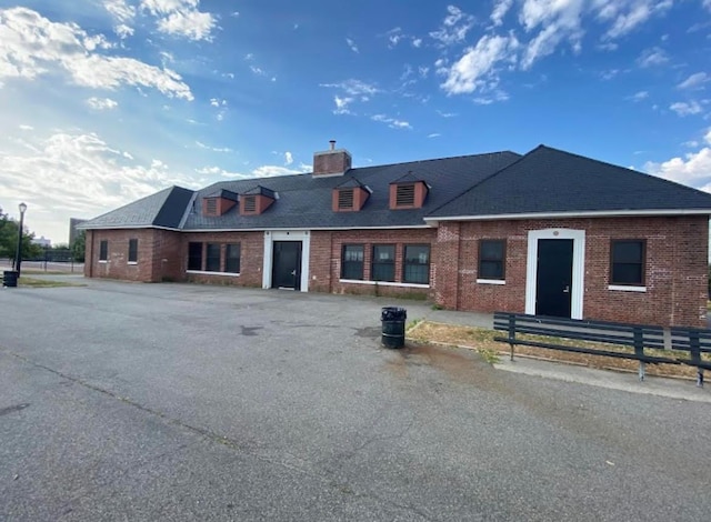 2813 W 30th St, Brooklyn, NY 11224 - view of front of property with a chimney, fence, brick siding, and roof with shingles