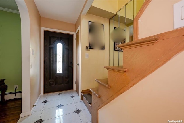 252-14 82nd Rd, Bellerose, NY 11426 - foyer entrance with a baseboard radiator, baseboards, stairs, arched walkways, and light tile patterned floors