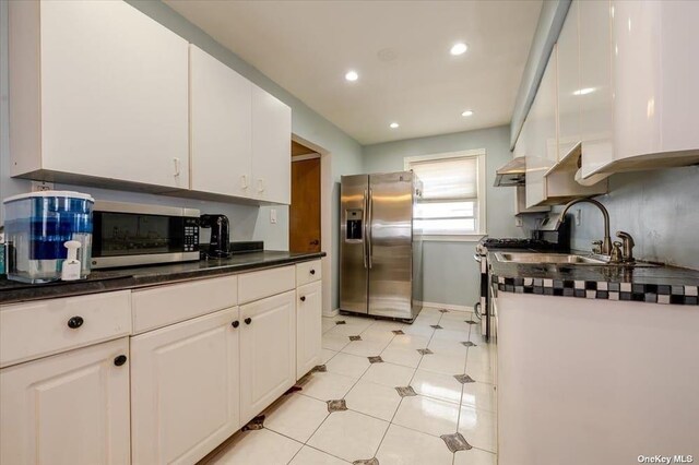 252-14 82nd Rd, Bellerose, NY 11426 - kitchen featuring appliances with stainless steel finishes, white cabinets, dark countertops, a sink, and recessed lighting