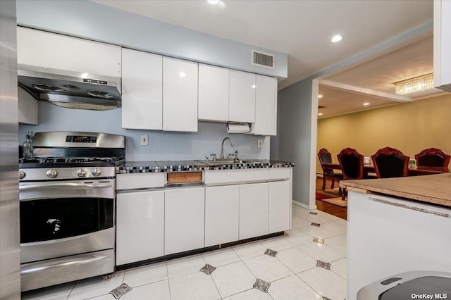 252-14 82nd Rd, Bellerose, NY 11426 - kitchen with gas stove, a sink, white cabinets, light tile patterned floors, and recessed lighting