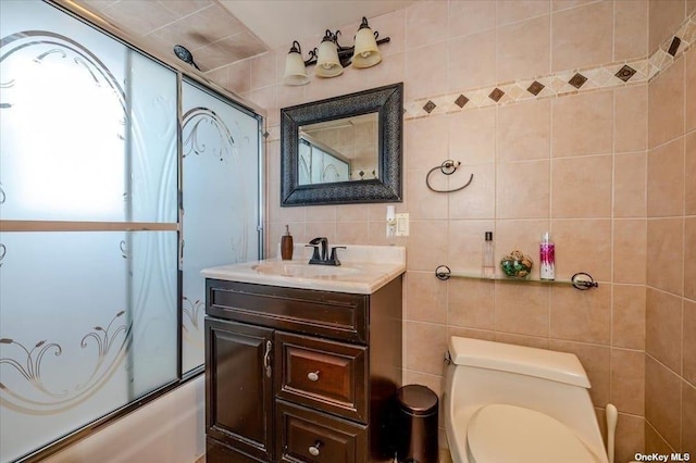 252-14 82nd Rd, Bellerose, NY 11426 - full bath featuring tile walls, toilet, bath / shower combo with glass door, vanity, and tasteful backsplash