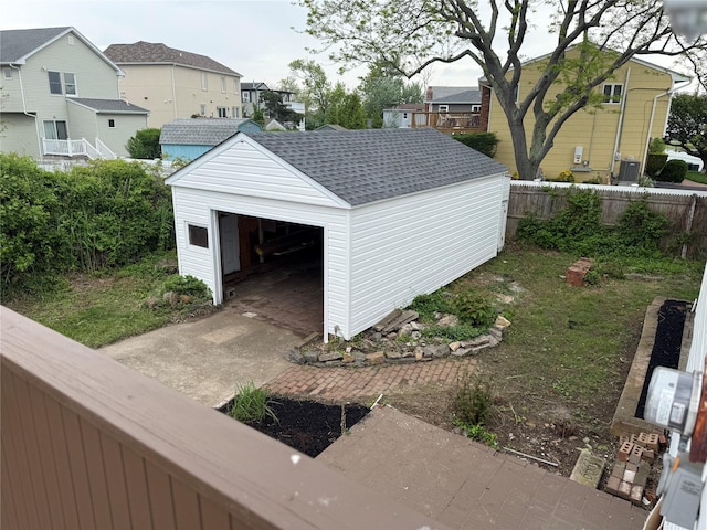 812 Beach St, Lindenhurst, NY 11757 - detached garage with fence, a residential view, and concrete driveway