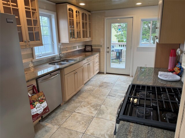 812 Beach St, Lindenhurst, NY 11757 - kitchen featuring a sink, appliances with stainless steel finishes, recessed lighting, glass insert cabinets, and dark stone countertops