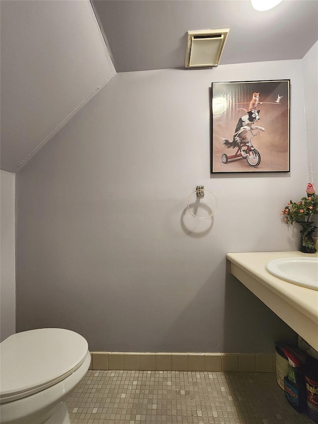 120-16 Cove Ct Unit 87A, College Point, NY 11356 - half bathroom featuring tile patterned floors, toilet, baseboards, lofted ceiling, and a sink