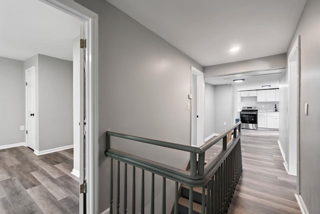 7 Grant St, Poughkeepsie, NY 12601 - hall featuring light wood-type flooring, baseboards, and an upstairs landing