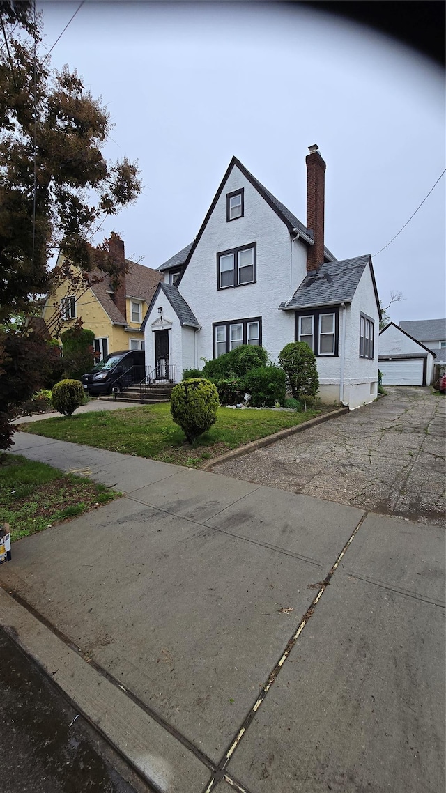 11419 179th St, Addisleigh Park, NY 11434 - view of front of house with a detached garage and a chimney
