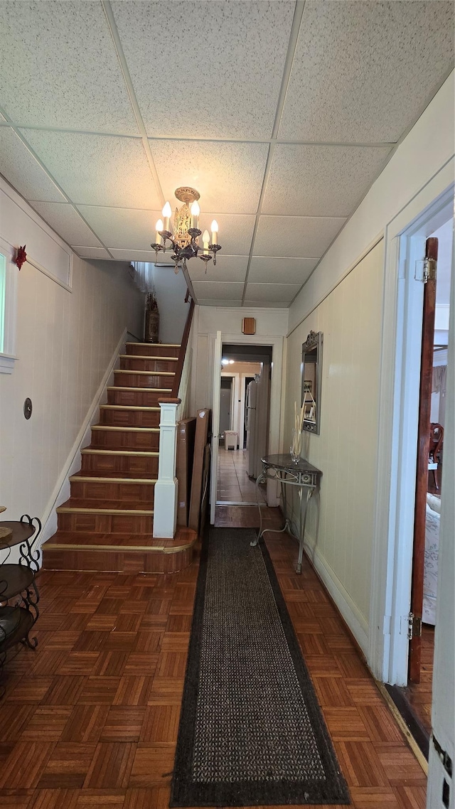 11419 179th St, Addisleigh Park, NY 11434 - stairway featuring a drop ceiling, baseboards, and a chandelier
