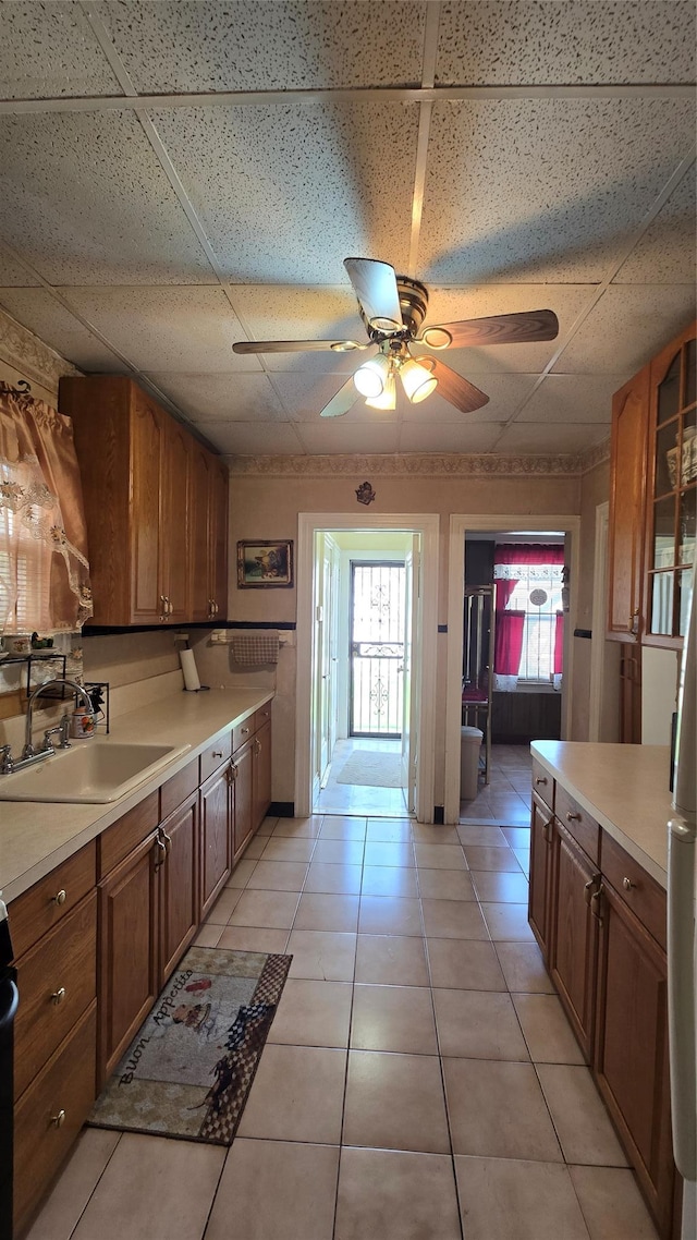 11419 179th St, Addisleigh Park, NY 11434 - kitchen with a sink, a paneled ceiling, ceiling fan, light countertops, and light tile patterned floors