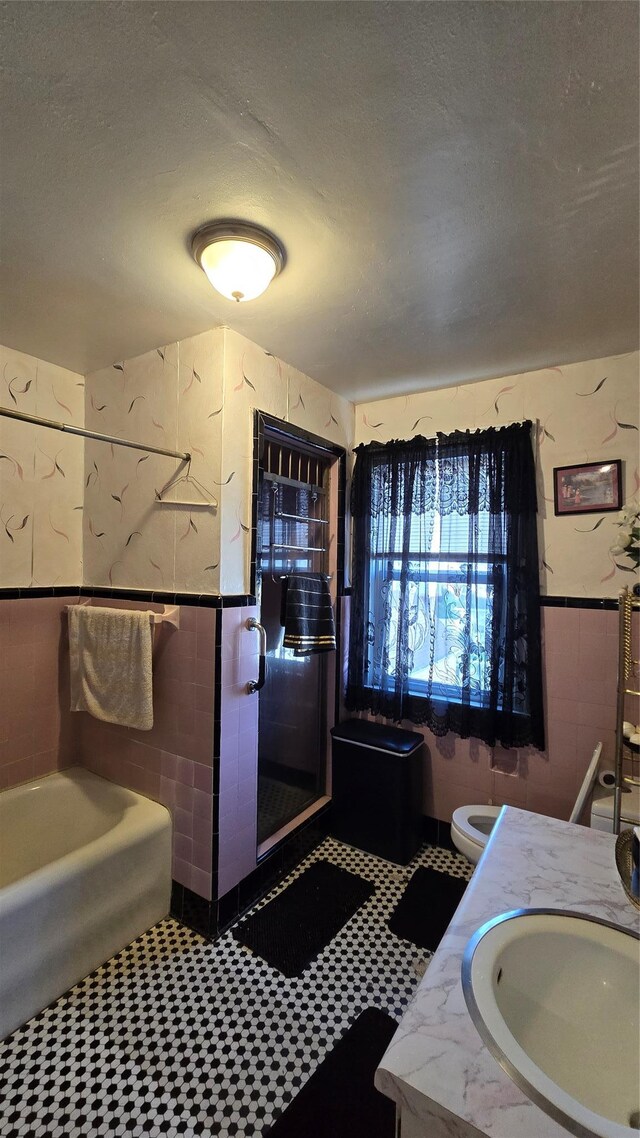 11419 179th St, Addisleigh Park, NY 11434 - bathroom featuring tile walls, an enclosed shower, tile patterned floors, toilet, and vanity