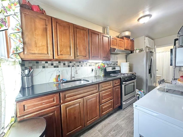 18 Sheridan Ave, Brooklyn, NY 11208 - kitchen featuring stainless steel appliances, a sink, under cabinet range hood, light wood-type flooring, and backsplash