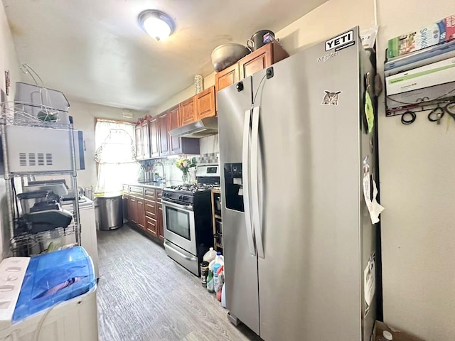 18 Sheridan Ave, Brooklyn, NY 11208 - kitchen with stainless steel appliances, under cabinet range hood, light wood finished floors, and a sink