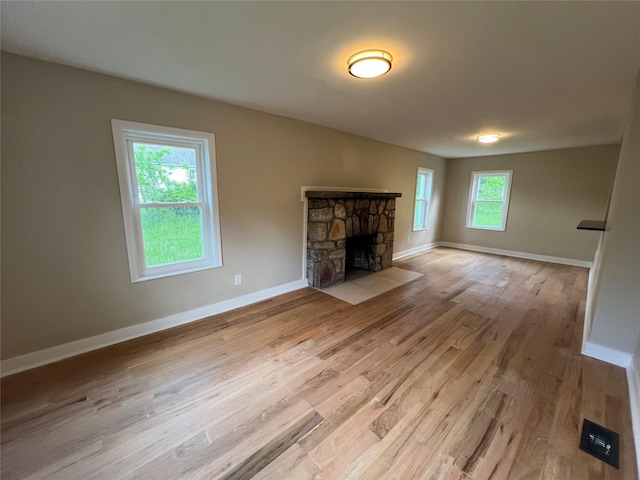 692 Burlingham Rd, Bloomingburg, NY 12721 - unfurnished living room with wood finished floors, baseboards, and a fireplace