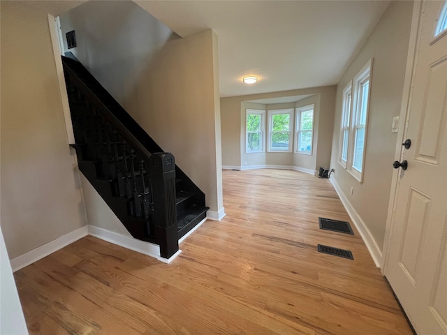 692 Burlingham Rd, Bloomingburg, NY 12721 - foyer entrance with light wood-style flooring, stairway, and baseboards