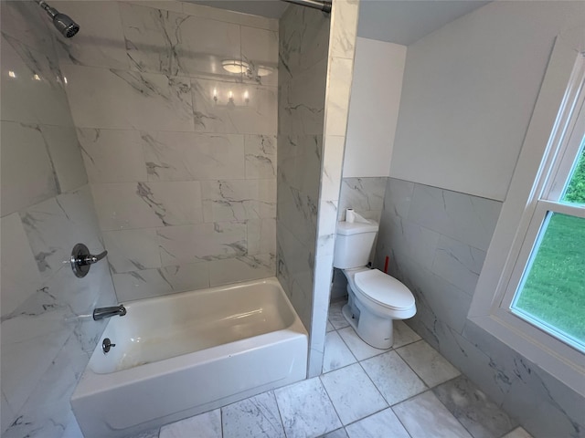 692 Burlingham Rd, Bloomingburg, NY 12721 - bathroom featuring tile walls, marble look tiles, toilet, and tub / shower combination