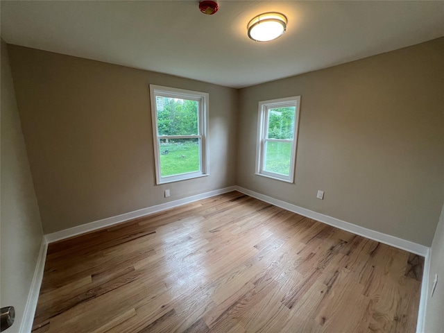 692 Burlingham Rd, Bloomingburg, NY 12721 - spare room with healthy amount of natural light, light wood-style floors, and baseboards
