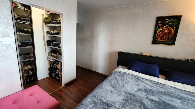 bedroom featuring wood finished floors and a closet