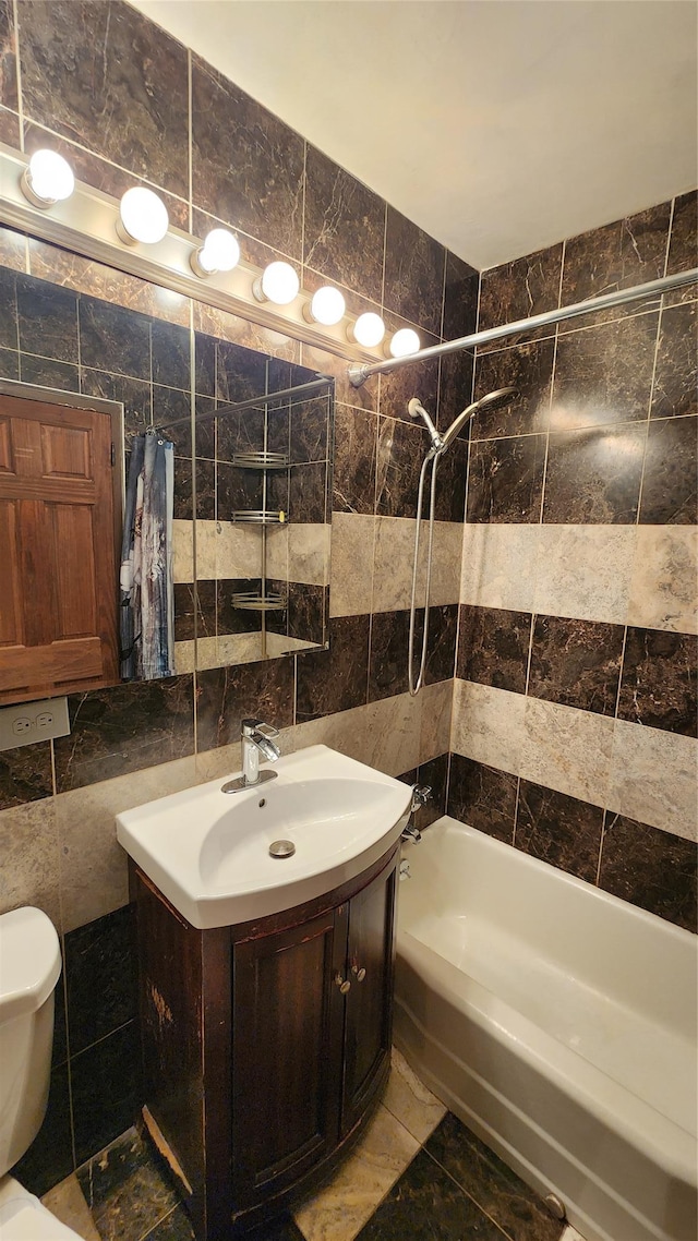 full bathroom featuring tile walls, toilet,  shower combination, and vanity