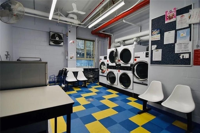 2944 W 5th St Unit 15S, Brooklyn, NY 11224 - community laundry with stacked washing machine and dryer, tile patterned floors, washing machine and clothes dryer, and concrete block wall