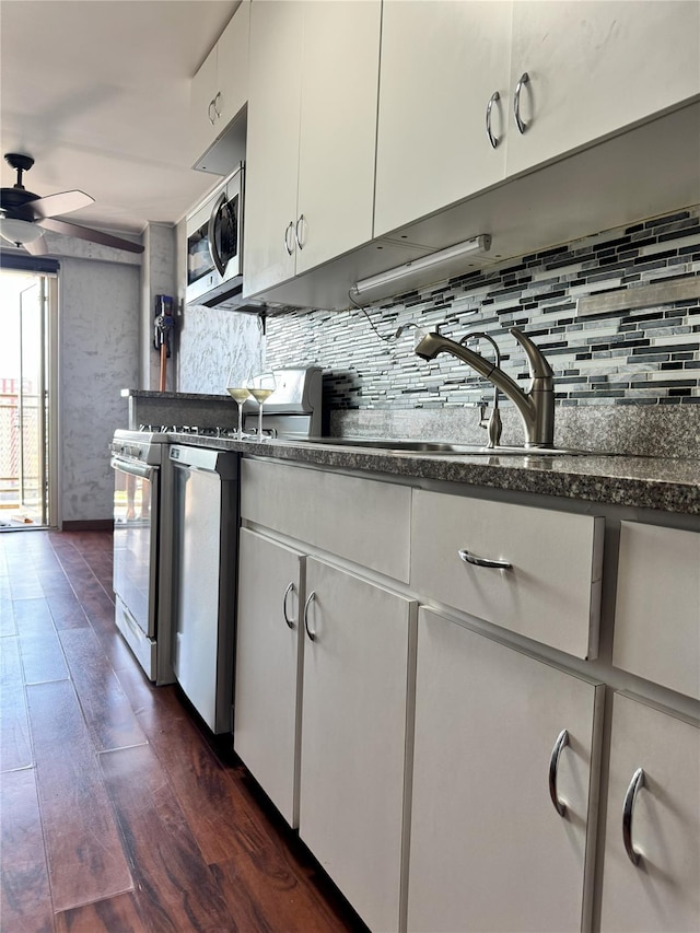 2944 W 5th St Unit 15S, Brooklyn, NY 11224 - kitchen with stainless steel microwave, range, decorative backsplash, a ceiling fan, and dark wood-style flooring