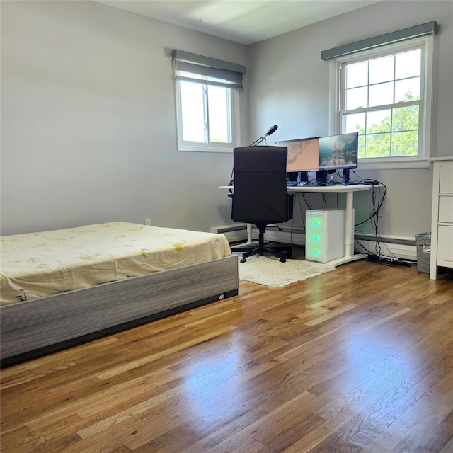 47 Barnum Ave, Plainview, NY 11803 - bedroom featuring wood finished floors, baseboard heating, and a desk