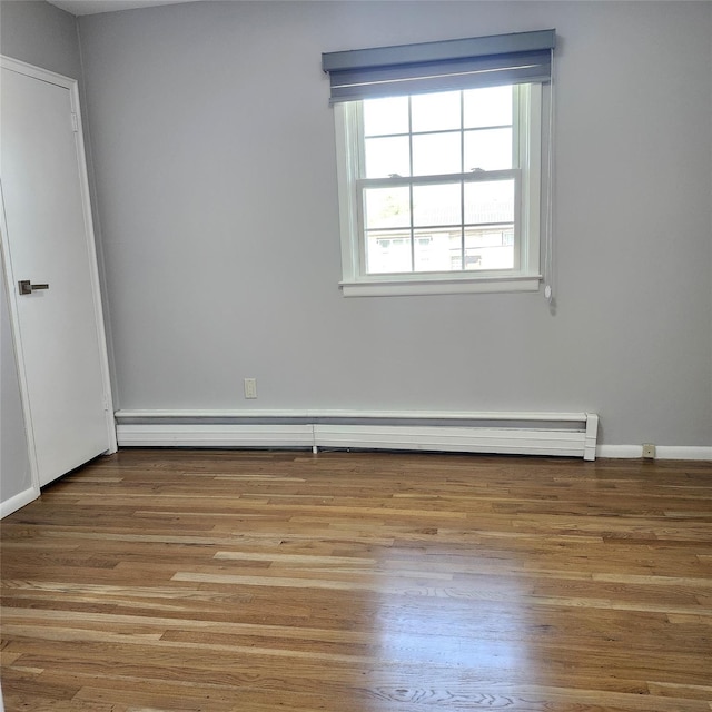 47 Barnum Ave, Plainview, NY 11803 - unfurnished room with baseboard heating, wood finished floors, and baseboards