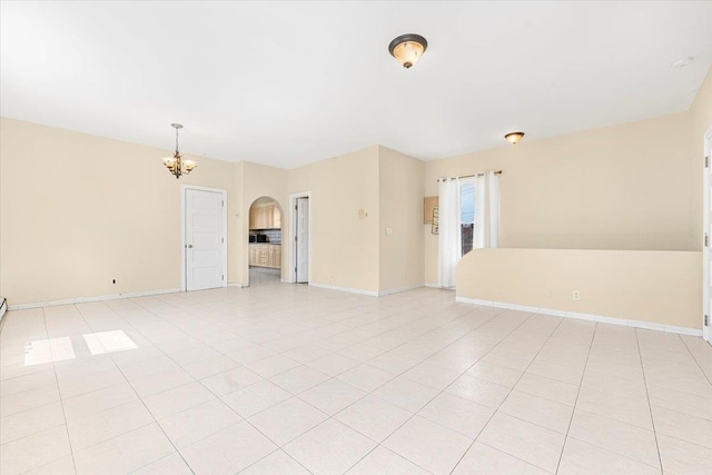 1465 Mayflower Ave, Bronx, NY 10461 - empty room with a chandelier, arched walkways, and baseboards