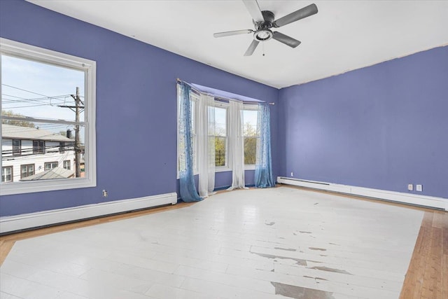 1465 Mayflower Ave, Bronx, NY 10461 - spare room featuring a baseboard radiator, baseboard heating, wood finished floors, ceiling fan, and baseboards