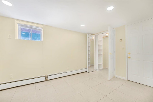 1465 Mayflower Ave, Bronx, NY 10461 - basement featuring baseboard heating, baseboards, light tile patterned floors, and recessed lighting