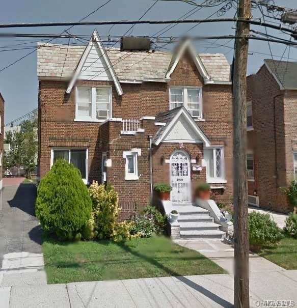 94-31 239th St, Floral Park, NY 11001 - view of front of house featuring brick siding and cooling unit
