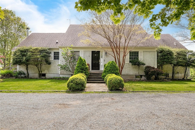 6 Beech Hollow Ct, Montauk, NY 11954 - view of front facade featuring a shingled roof and a front yard