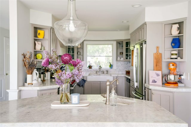 6 Beech Hollow Ct, Montauk, NY 11954 - kitchen with open shelves, stainless steel appliances, light stone countertops, decorative light fixtures, and a sink