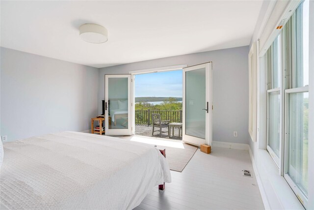 6 Beech Hollow Ct, Montauk, NY 11954 - bedroom with access to exterior, baseboards, and wood finished floors